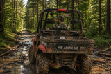 Person driving an Arctic Cat Prowler side-by-side on a muddy forest trail. TerraRider rear UTV windshields available for 2006–2010 models.