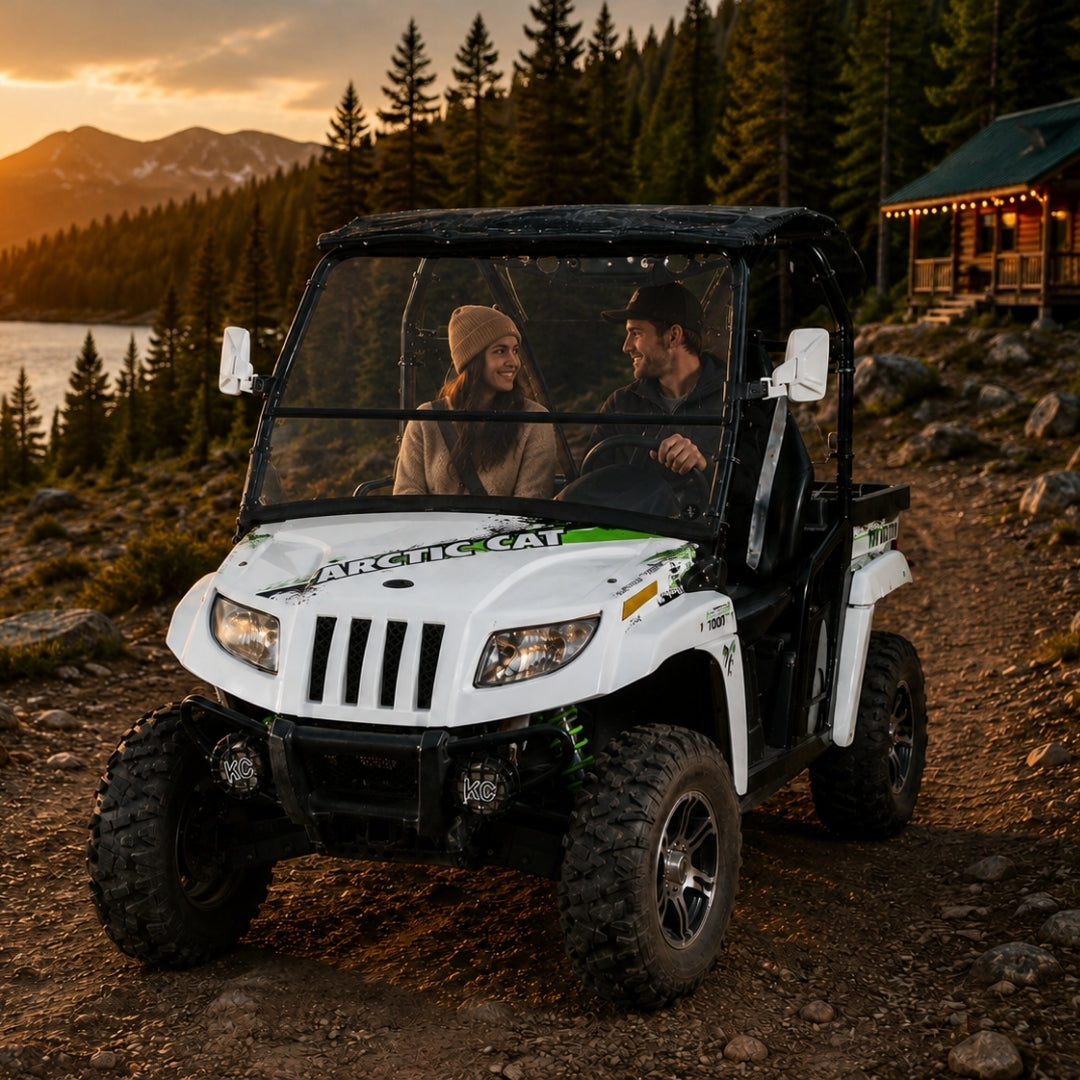 2011-2014 Arctic Cat Prowler with a TerraRider tilting windshield parked outside a cabin at sunset