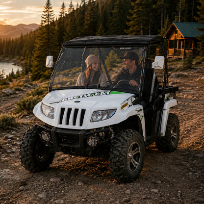 White 2011-2014 Arctic Cat Prowler with a TerraRider full front windshield parked outside a cabin