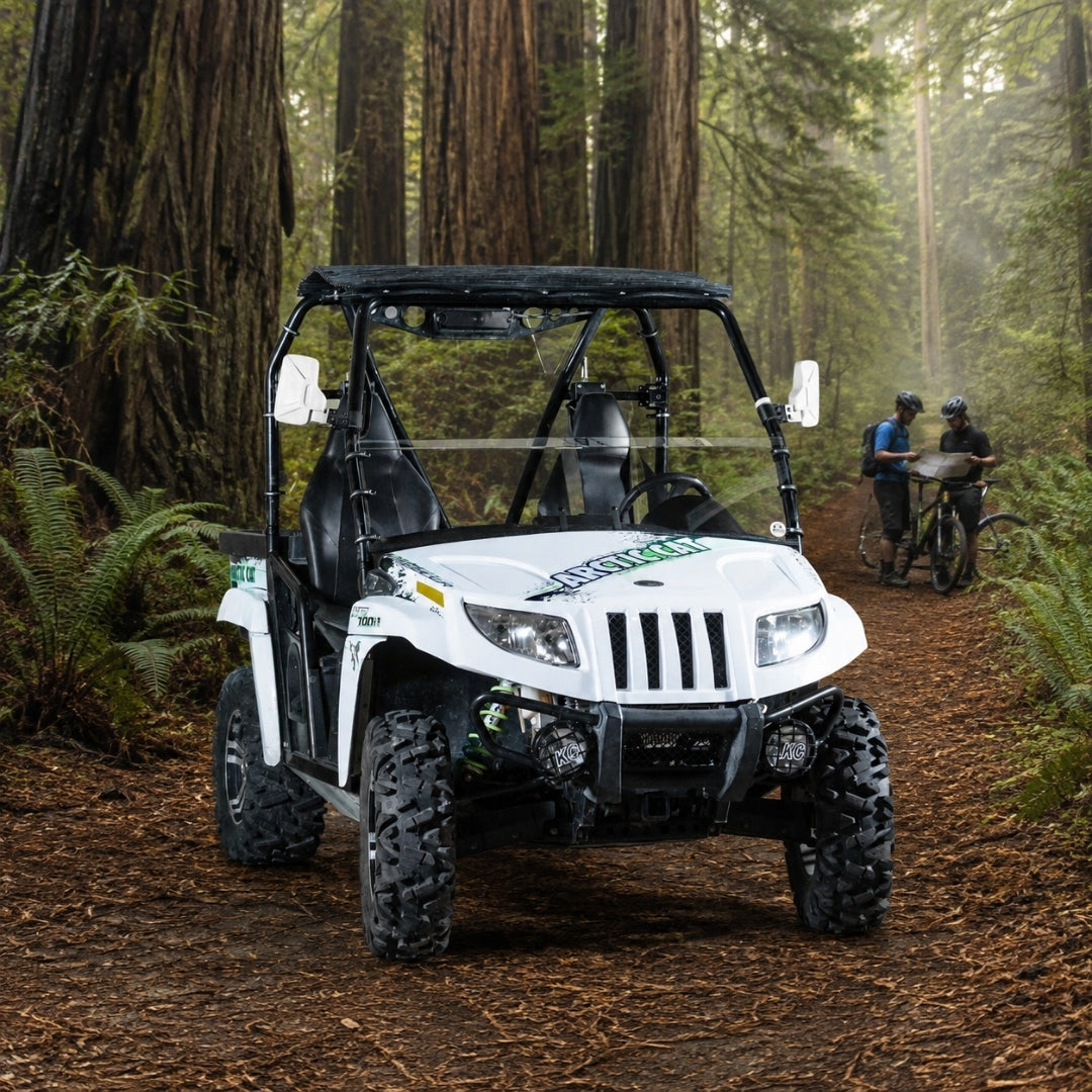 White Arctic Cat Prowler with half windshield on a forest trail among redwood trees