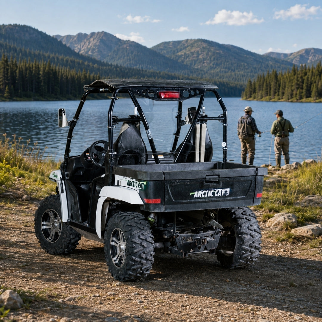 White Arctic Cat Prowler with back windshield parked by a mountain lake at a campsite