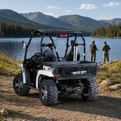 White Arctic Cat Prowler with back windshield parked by a mountain lake at a campsite