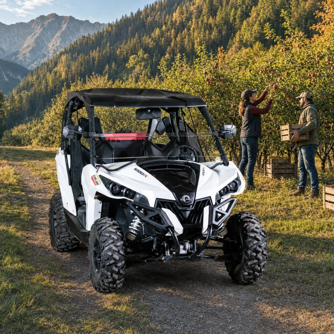 People standing beside a Maverick fitted with a half windshield on an autumn mountain trail
