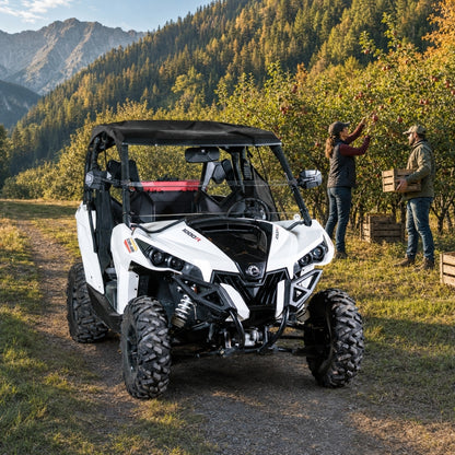 People standing beside a Maverick fitted with a half windshield on an autumn mountain trail