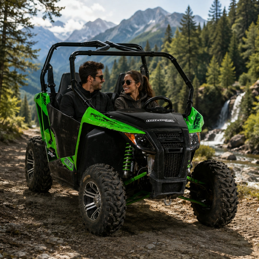Two riders in an Arctic Cat Wildcat Trail with a TerraRider full front windshield, on a mountain trail