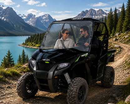 Two riders in a 2015-2017 Arctic Cat Prowler with a TerraRider full front windshield, parked by a mountain lake