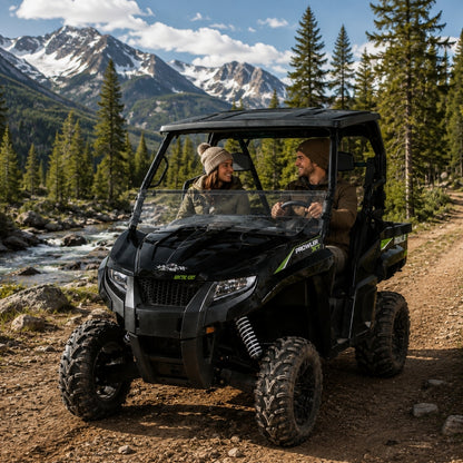 Black Arctic Cat Prowler with tilting windshield on a mountain trail with snowy peaks behind