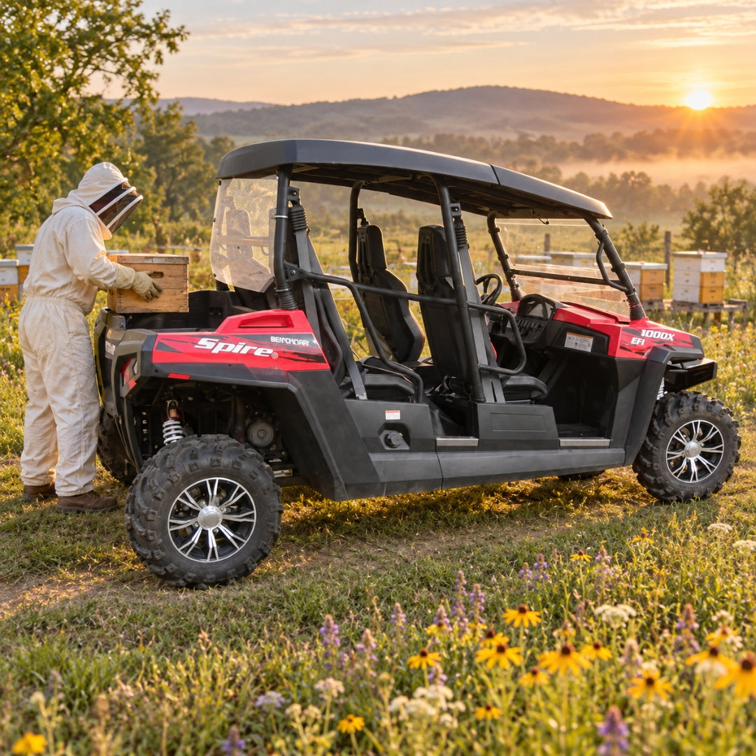 Person beside a red Spire 1000X in a wildflower meadow at sunset, back panel enclosing the rear cab