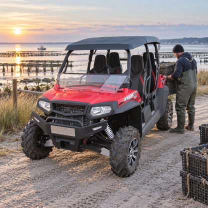 Red four-door Spire 1000 with tilting windshield parked on a lakeside road at sunrise, owner loading gear. gallery-1
