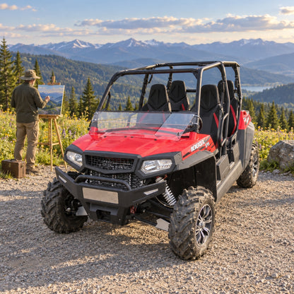 Rider standing beside a red four-door Spire 1000 with tilting windshield on a gravel overlook below snowy peaks. gallery-2