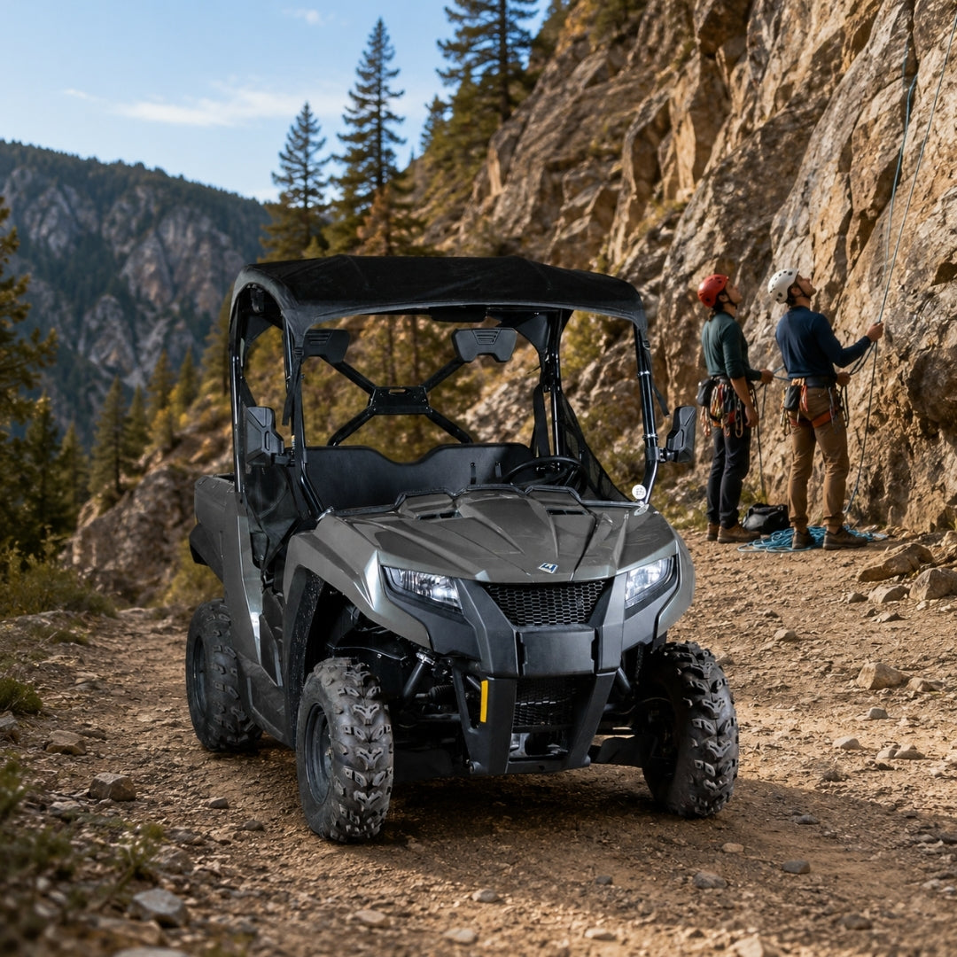 Gray Arctic Cat Prowler 500 with full windshield on a mountain road with riders alongside