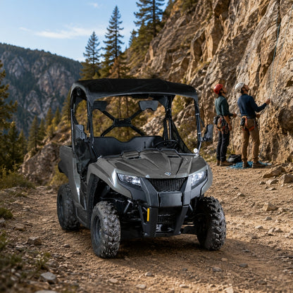 Gray Arctic Cat Prowler 500 with full windshield on a mountain road with riders alongside