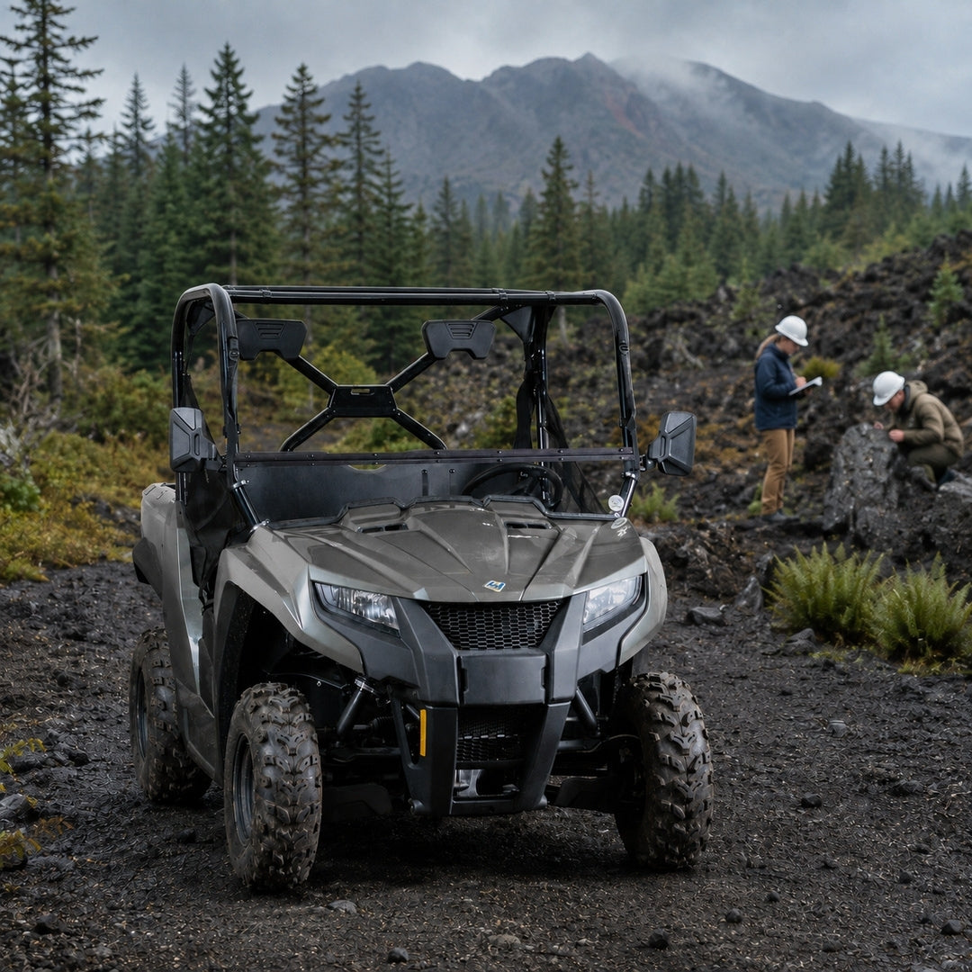 Gray Arctic Cat Prowler 500 with tilting windshield on a mountain trail with riders behind