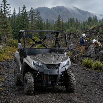 Gray Arctic Cat Prowler 500 with tilting windshield on a mountain trail with riders behind