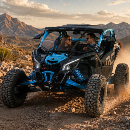 Riders in a blue Maverick X3 with half windshield on a desert ridge at sunset. gallery-1
