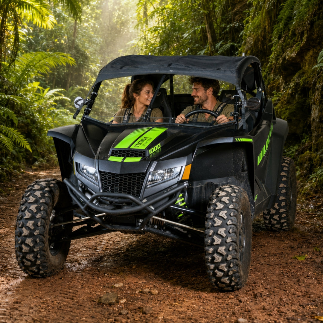 Two riders in a black Arctic Cat Wildcat XX with full windshield on a jungle trail