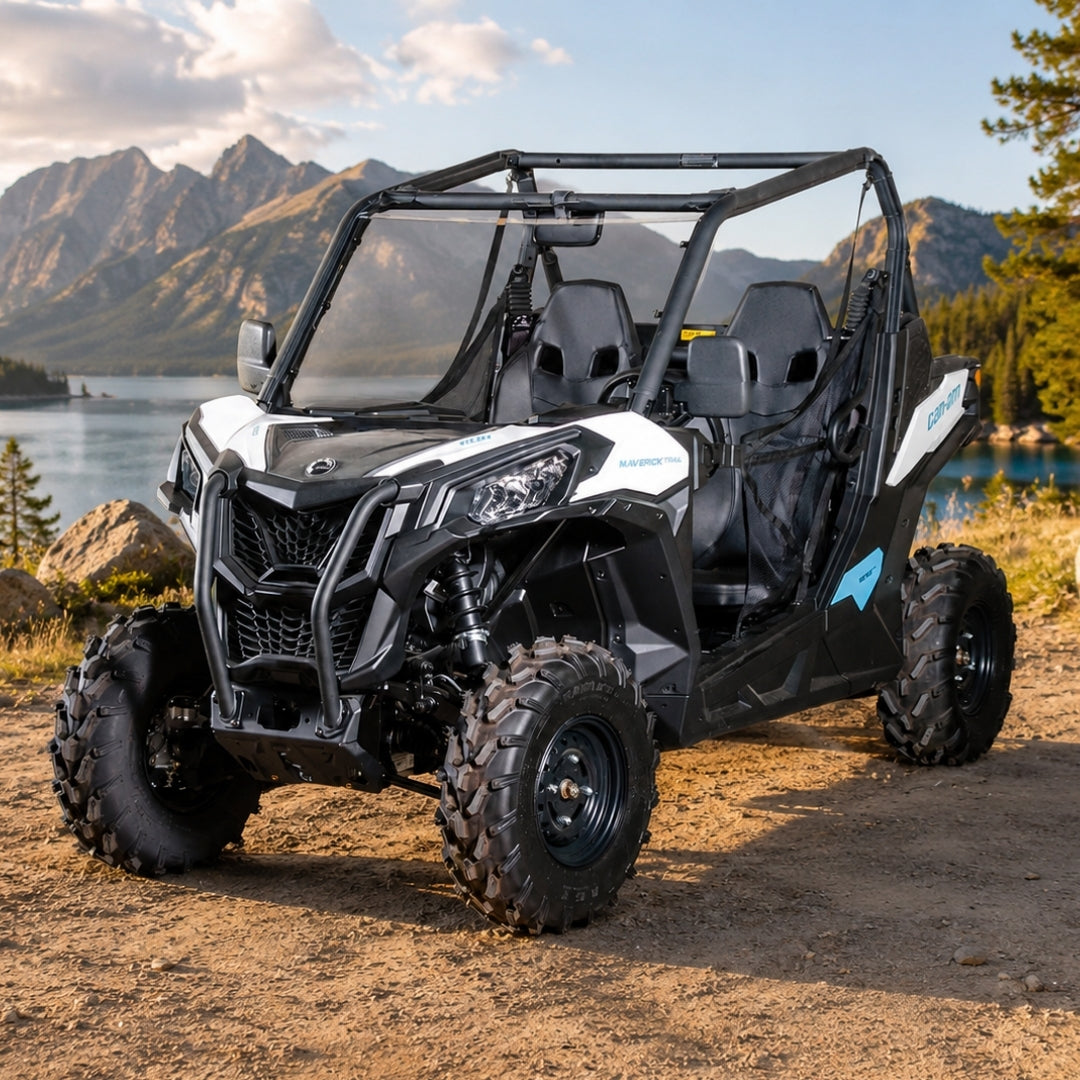 Maverick Sport with full windshield parked on a lakeshore beach with pines and cliffs behind