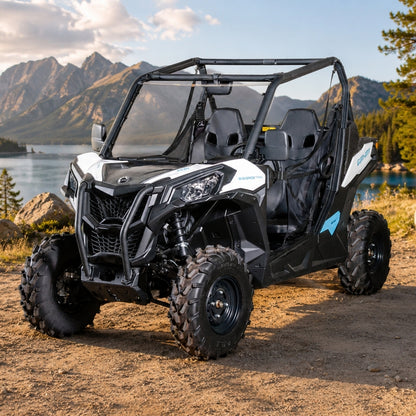 Maverick Sport with full windshield parked on a lakeshore beach with pines and cliffs behind
