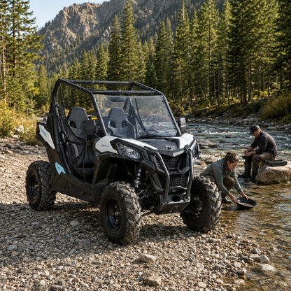 Black Maverick Trail with full windshield on a dirt trail below a rocky mountain face