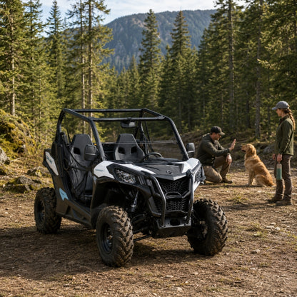 Riders gathered beside a Maverick Sport with half windshield on a pine-lined mountain trail