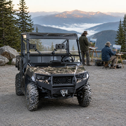 Camo Arctic Cat Prowler Pro with tilting windshield parked on a gravel overlook with people nearby. gallery-1